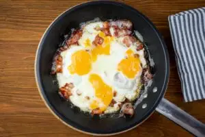 A Frying Pan with Bacon and Eggs